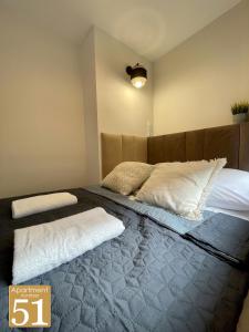 a bedroom with a large bed with white pillows at Piękny przytulny apartament - blisko akwenu wodnego in Radom