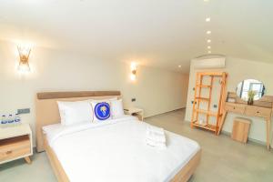 a bedroom with a large bed and a dressing room at Sulty's Alaçatı in İzmir