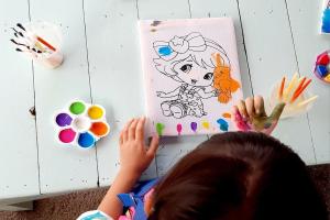 a child is playing with a coloring book at See Sky Resort in Ban Sao Thong