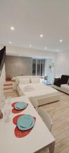 a living room with a table with plates on it at BARBARA Classy Apartments 103, Wellness in Syracuse