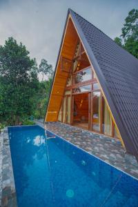 a house with a swimming pool in front of it at Tea Cabins in Ella