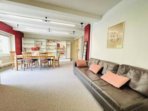 a living room with a couch and a dining room at Duplex Laon'Tre-Deux in Laon +26 photos
