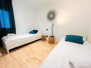a room with two beds and a mirror on the wall at Ecochic Apartment in Fuengirola Center in Fuengirola
