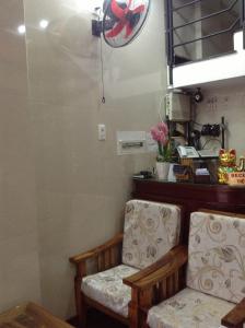 a room with two chairs and a fan at Ti Ti Room For Rent in Ho Chi Minh City