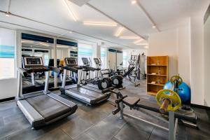 a gym with several treadmills and cardio machines at Sunday Hotel Chandigarh Zirakpur in Zirakpur