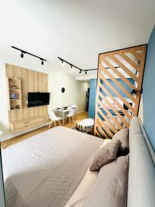 a bedroom with a bed and a dining room at Blue Luxury Apartment in Golem