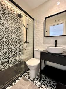 a bathroom with a toilet and a sink and a shower at Ecochic Apartment in Fuengirola Center in Fuengirola