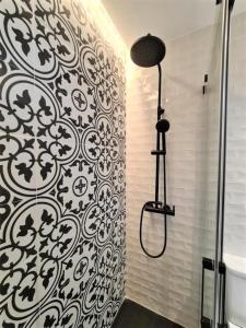 a bathroom with a black and white pattern on the wall at Ecochic Apartment in Fuengirola Center in Fuengirola