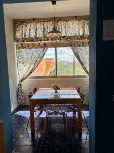 a dining room with a table and a large window at Casamare 83 in Torre Canne