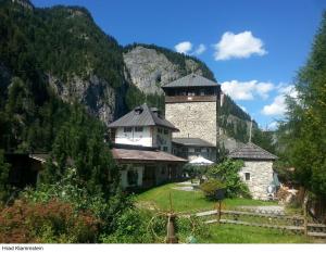 a building with a tower in the middle of a mountain at Ferienwohnungen Lend 3 in Lend