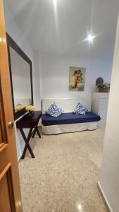 a room with a bed and a mirror and a table at FARO PLAYA in Cullera +15 photos