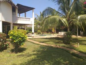a house with a garden and a swimming pool at Villa Simba in Galu