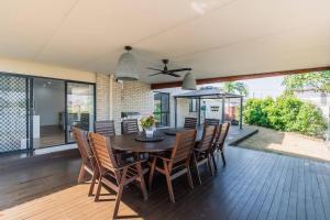 a dining room with a table and chairs at KozyGuru Gold Coast Broadbeach Holiday Home in Gold Coast