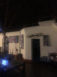 een kamer met een tafel en wat foto's aan de muur bij Simba hoch2 in Galu