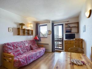 a living room with a couch and a table at Studio Montvalezan-La Rosière, 1 pièce, 4 personnes - FR-1-398-561 in La Rosière