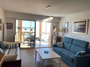 a living room with a blue couch and a table at Appartement Vieux-Boucau-les-Bains, 2 pièces, 5 personnes - FR-1-379-38 in Vieux-Boucau-les-Bains