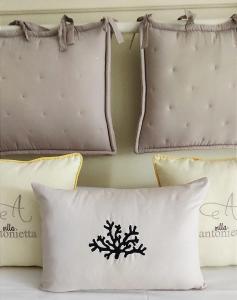 a group of pillows on top of a bed at Villa Antonietta Ischia in Ischia