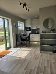 a kitchen and dining room with a table and a dining room at Ebbas stuga in Färjestaden