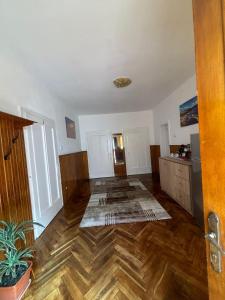 uma sala de estar vazia com piso de madeira em Casa RoxAmy em Orşova