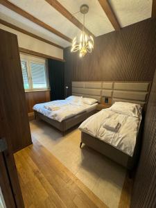 a bedroom with two beds and a chandelier at Era Home Family in Murg