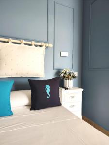 a bedroom with a bed with blue walls at Villa Antonietta Ischia in Ischia