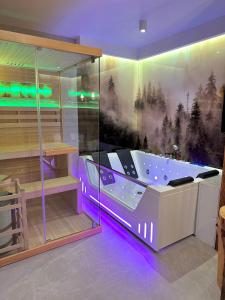 a bathroom with a tub with purple lights in it at Pod Horodkiem in Cisna