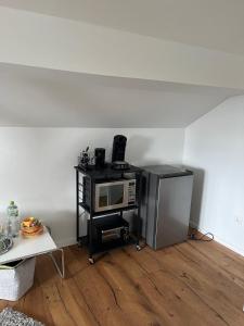 a microwave sitting on a stand in a room at Harkort Seeblick 1 in Herdecke