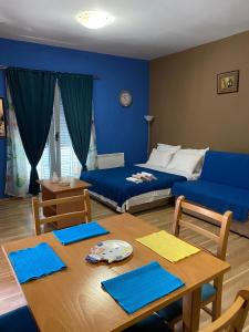 sala de estar con cama y mesa con sofá azul en Apartmani Jaz 24, en Budva