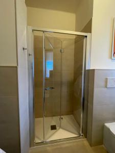 a shower with a glass door in a bathroom at La Casa di Simo Appartamento con terrazzo in Salice Terme