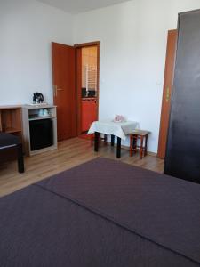 a living room with a table and a kitchen at Korwin in Rewal +11 photos