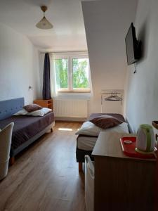 a bedroom with two beds and a window at Korwin in Rewal