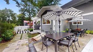 a patio with a table and chairs and an umbrella at Fern Creek in South Haven +80 photos
