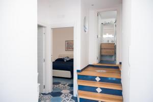 a room with a staircase leading to a bedroom at Armarì Panoramic Flat in Vietri