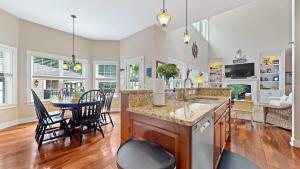 a kitchen and dining room with a table and chairs at Inn Like a Lamb in South Haven +79 photos