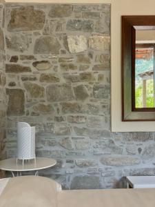 kamienna ściana w pokoju z lustrem w obiekcie Agriturismo Piano di Andrea w mieście Ostigliano