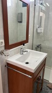 a bathroom with a white sink and a shower at Central Seaview Apartment Puerto del Carmen in Puerto del Carmen