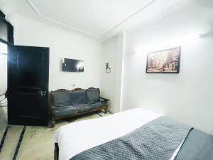 A bed or beds in a room at Hotel Aura Opposite Max Hospital