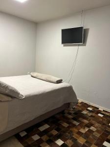 Un pat sau paturi într-o cameră la Norte Hospedagem
