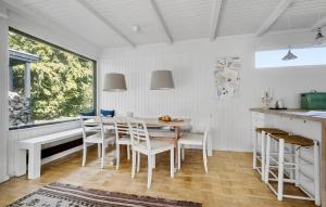 a kitchen and dining room with a table and chairs at 3 Bedroom Awesome Home In Vejby in Vejby