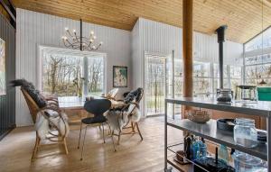 a kitchen with a table and chairs in a room at 4 Bedroom Pet Friendly Home In Strandby in Strandby