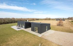 a black house sitting on top of a field at Beautiful Home In Haderslev With Kitchen in Haderslev