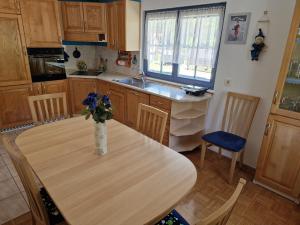a kitchen with a table with a vase of flowers on it at Apartment Luka at Soča & Koritnica confluence in Bovec