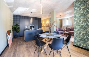 a dining room and living room with a table and chairs at Amazing Apartment In Podstrana With Wifi in Podstrana
