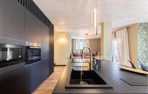 a kitchen with a black counter top with a sink at Amazing Apartment In Podstrana With Wifi in Podstrana