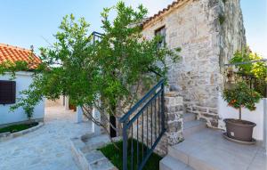 a stone building with a staircase next to a tree at Lovely Home In Slivnica With Wifi in Slivnica