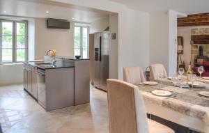 a kitchen and dining room with a table and chairs at 3 Bedroom Stunning Home In Saint Robert in Saint-Robert