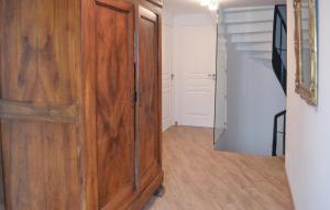 a wooden cabinet in a hallway with a staircase at 3 Bedroom Stunning Home In Saint Robert in Saint-Robert