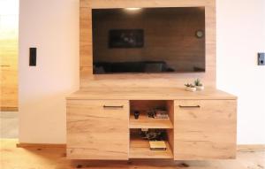 a large wooden cabinet with a tv on top at Nice Apartment In Maria Alm Am Steinernen With Wifi in Bachwinkl