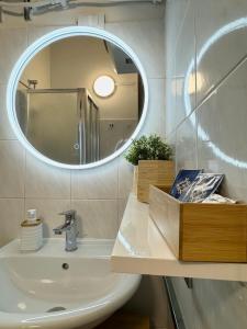 a bathroom with a sink and a mirror at Il gufo barocco in Noto +15 photos