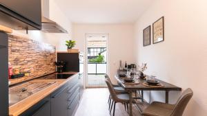 a kitchen with a table with chairs and a sink at Barrierefrei I free parking I Terasse I Netflix in Quedlinburg